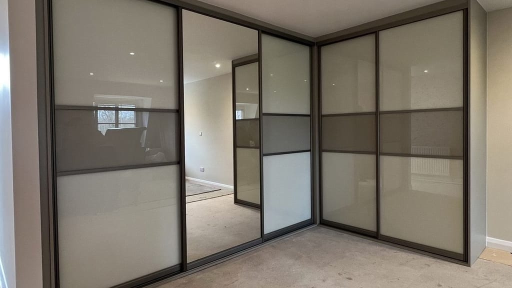 Full-wall sliding wardrobe design for small apartment bedroom